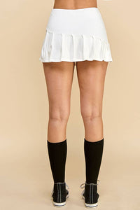 KNIFE PLEATED SKORT: SOFT WHITE